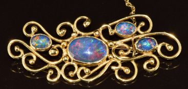 A yellow metal brooch set with four opal triplets (tests as 18k gold), 11.9g, 6cm