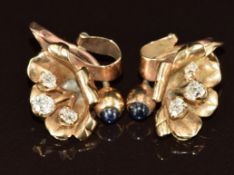 A pair of 9ct gold clip earrings each set with three old cut diamonds, the largest approximately 0.