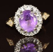 A 9ct gold ring set with an oval cut amethyst surrounded by diamonds, 4.2g, size K