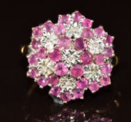 A 9ct gold ring set with rubies and diamonds in a large cluster, 3.7g, size M