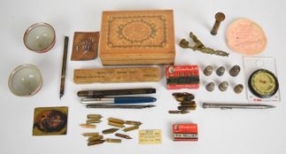 Collection of vintage pens, nibs, compass, trench art seal, silver thimbles, etc including boxed