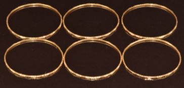 Six yellow metal bangles from Bahrain (tests as 20-22ct), 26.2g, 4.8cm
