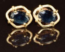 A pair of 14k gold earrings each set with an oval cut sapphire, 1g