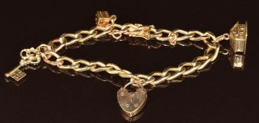 A 14k gold charm bracelet with three 14k gold charms including a key, house opening to reveal two
