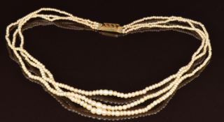 A c1900 three strand pearl necklace with yellow metal clasp (tests as 14k), 12.2g, 39cm