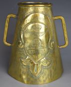 Arts & Crafts conical twin handled brass tankard, repoussé decorated with coat of arms and Urbis