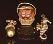 Three 9ct gold charms comprising one in the form of a basket and two dogs, one in the form of a