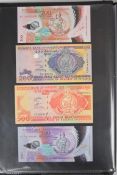 Collection of approximately 200 world banknotes in an album, including Vanuatu, Poland, Krygystan,