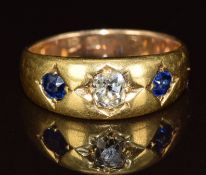 A c1900 18ct gold ring set with an old cut diamond of approximately 0.3ct and two oval cut