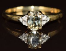 A 9k gold ring set with an oval cut zultanite and six diamonds, 1.6g, size N