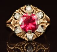 An 18ct gold ring set with a synthetic ruby and quartz, 6.8g, size P