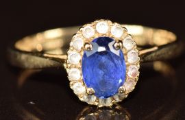 A 9ct gold ring set with a synthetic sapphire surrounded by white sapphires, 2.4g, size P