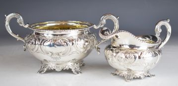 Victorian hallmarked silver sugar bowl and milk jug with embossed floral decoration and gadrooned