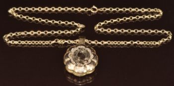 A yellow metal chain and Victorian locket with faceted edges