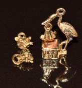Two 9ct gold charms, one in the form of a cat and the other a stork with a baby boy, 4g