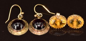 A pair of Victorian earrings each set with a garnet cabochon and a pair of earrings each set with an
