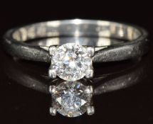 A platinum ring set with a round brilliant cut diamond of approximately 0.6ct, with certification,