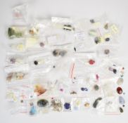 A collection of loose gemstones including agate, howlite, onyx, labradorite, amber, onyx and tiger's