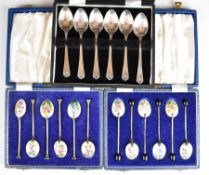 Three cased sets of six hallmarked silver spoons, comprising two pairs of floral guilloché enamel