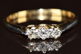 An 18ct gold ring set with three diamonds, 1.8g, size M