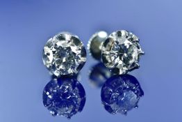 A pair of French 18k white gold earrings each set with a round cut diamond of approximately 1ct,