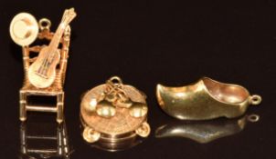 Three 14k gold charms including clog and tambourine, 8.8g