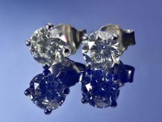 A pair of 18k white gold earrings each set with a round brilliant cut diamond of approximately 0.
