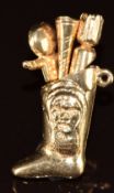 A yellow metal charm in the form of a Christmas stocking with a cracker, horn and golly, 7.1g