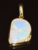 A 18k gold pendant set with an opal and two diamonds, 3.9g, 2.8cm