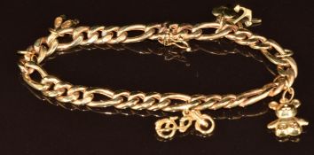 A 9ct gold charm bracelet with four 9ct gold charms including bike, hope, faith and love, teddy bear