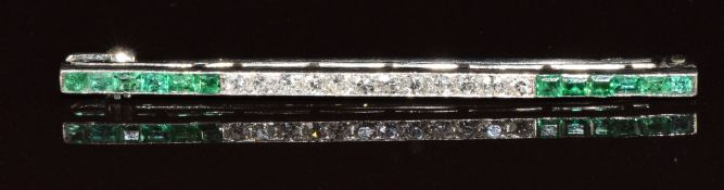 Cartier Paris platinum brooch set with calibre cut emeralds and transitional cut diamonds,
