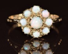 A 9ct gold ring set with a cluster of opals, 2.4g, size M