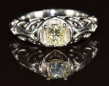 A platinum ring set with a square brilliant cut natural light yellow diamond of approximately 0.