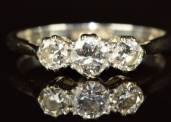 An 18ct white gold ring set with three round cut diamonds in a platinum setting, the centre