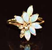 An 18ct gold ring set with marquise cut opals and diamonds, 3.6g, size P