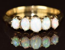 An 18ct gold ring set with five opal cabochons, 2.6g, size M/N