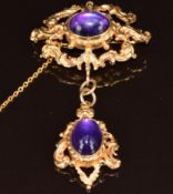 A 9ct gold brooch set with two amethyst cabochons, 17.3g, 7cm