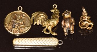 A 9ct gold St Christopher charm / pendant, miniature penknife charm, 9ct gold Teddy bear charm,