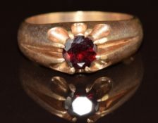 A 9ct gold ring set with a round cut garnet, 8g, size W
