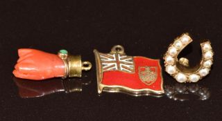 A 9ct gold Edwardian charm in the form of a horseshoe set with pearls (1.3g) and a charm in the form