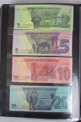 Collection of approximately 200 world banknotes in an album, including Turkey, Croatia, Laos,