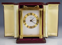 Looping Switzerland modern miniature carriage clock with brass case, raised on four turned feet,