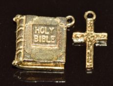 A 9ct gold charm in the form of a bible opening to reveal the Lords Prayer and a 9ct gold cross