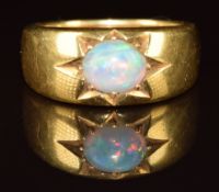 An 18ct gold ring set with an oval opal cabochon in a star setting, c1900, 11.1g, size N