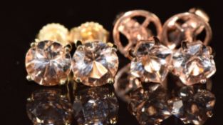 A pair of 9k gold earrings each set with a round cut morganite and a pair of 9k rose gold earrings
