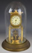 Gilt and polished brass torsion or anniversary clock with disc type pendulum, under glass dome,