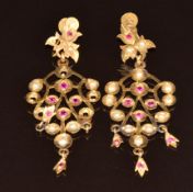 A pair of yellow metal earrings set with pearls and rubies from Bahrain (tests 20-22k gold), 7cm