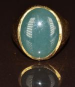 A 14k gold ring set with a quartz cabochon, 10.8g, size R