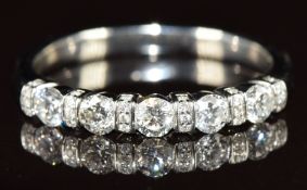 A platinum half eternity ring set with five round cut diamonds, each approximately 0.1ct,