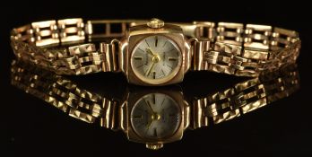 Accurist 9ct gold ladies wristwatch with gold hands, two-tone baton hour markers, silver dial and